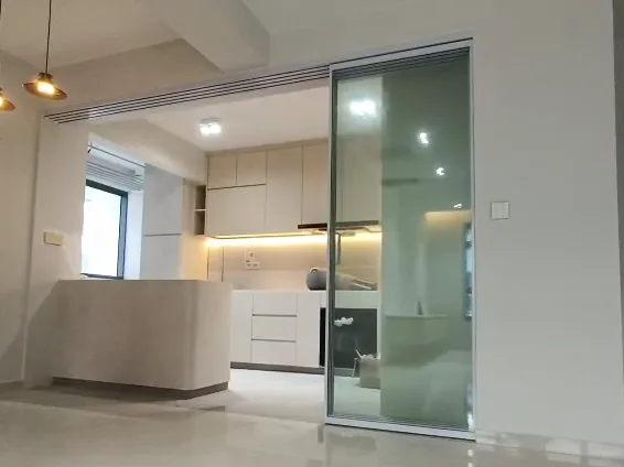 The same door open, its panels stacked at the right, leaving the kitchen opening clear